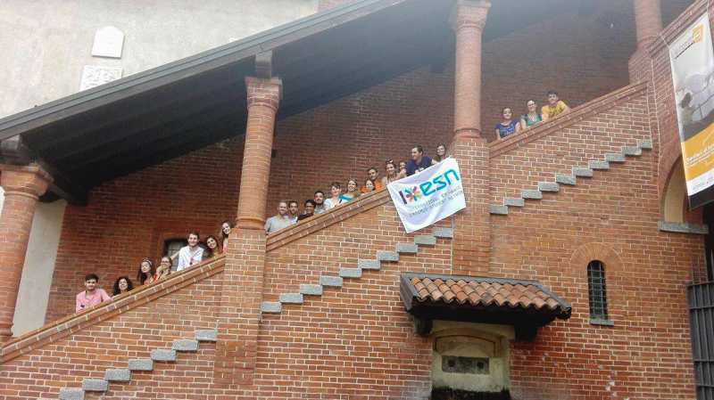 Participants of Eduk8 Novara standing on the staircase of an old brick building